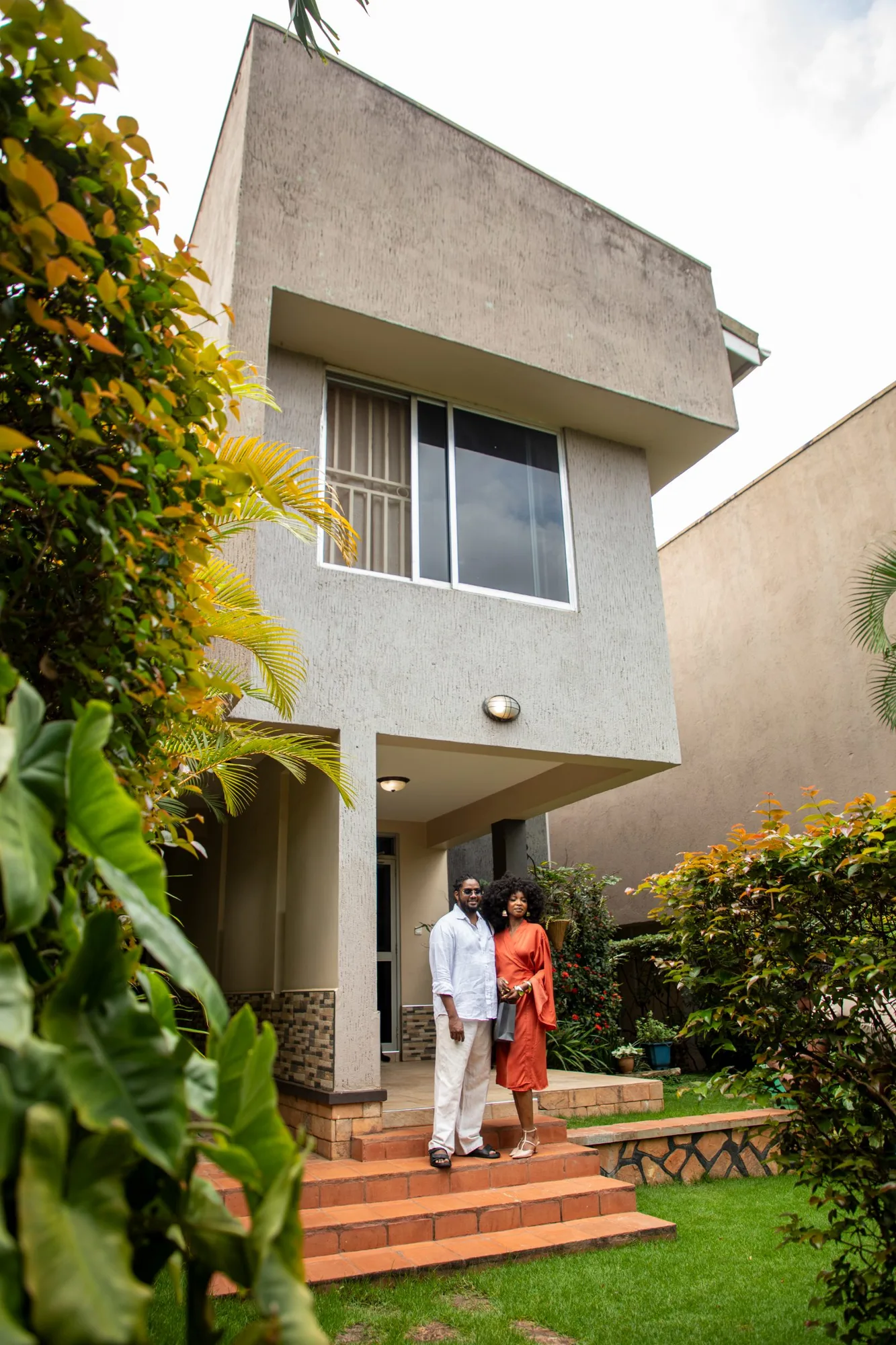The owners of The Pearl Cottages standing in the garden entrance