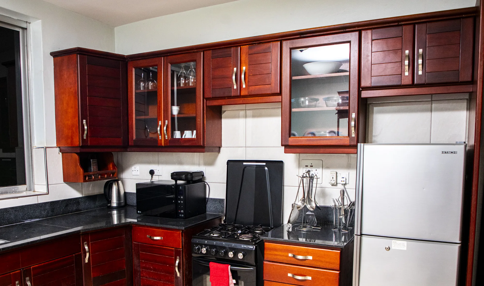 The Tulip two-bedroom self-catering kitchen with warm wood cabinetry