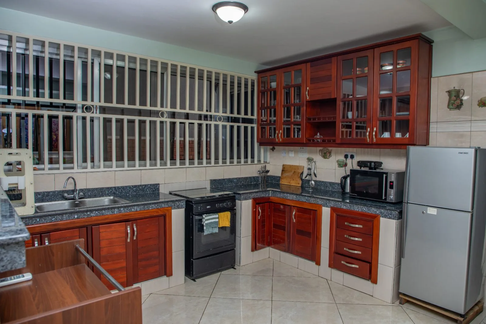 Fully equipped kitchen with fridge, cooker and microwave